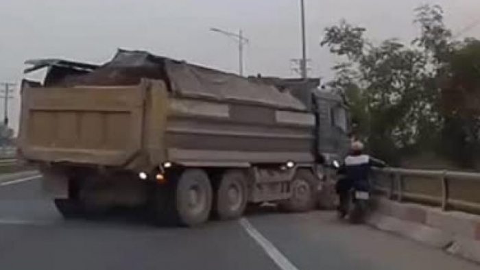 Bỏ xe máy trôi vào gầm xe tải, nữ tài xế nhanh trí thoát thân